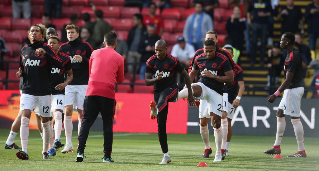 Chris Smalling, Ashley Young and Antonio Valencia of Manchester United warm up ahead of the Premier League match between Watford FC and Manchester ...