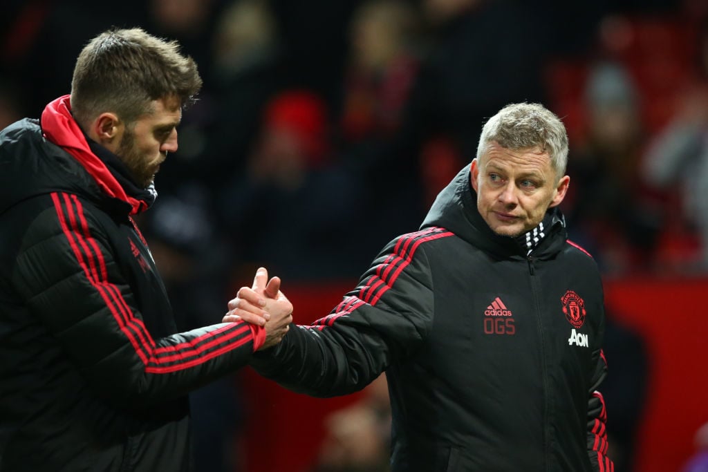 MANCHESTER, ENGLAND - JANUARY 29: Michael Carrick, Manchester United coach shakes hands with Ole Gunnar Solskjaer, Interim Manager of Manchestr United after the Premier League match between Manchester United and Burnley at Old Trafford on January 29, 2019 in Manchester, United Kingdom. 