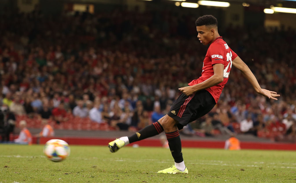 CARDIFF, WALES - AUGUST 03: Mason Greenwood of Manchester United scores during a penalty shoot-out during the 2019 International Champions Cup match between Manchester United and AC Milan at Principality Stadium on August 03, 2019 in Cardiff, Wales. 
