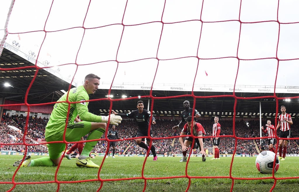 SHEFFIELD, ENGLAND - SEPTEMBER 28:   Dean Henderson of Sheffield United fails to saves Georginio Wijnaldum of Liverpool (obscure) shot which leads to Liverpools first goal  during the Premier League match between Sheffield United and Liverpool FC at Bramall Lane on September 28, 2019 in Sheffield, United Kingdom. 