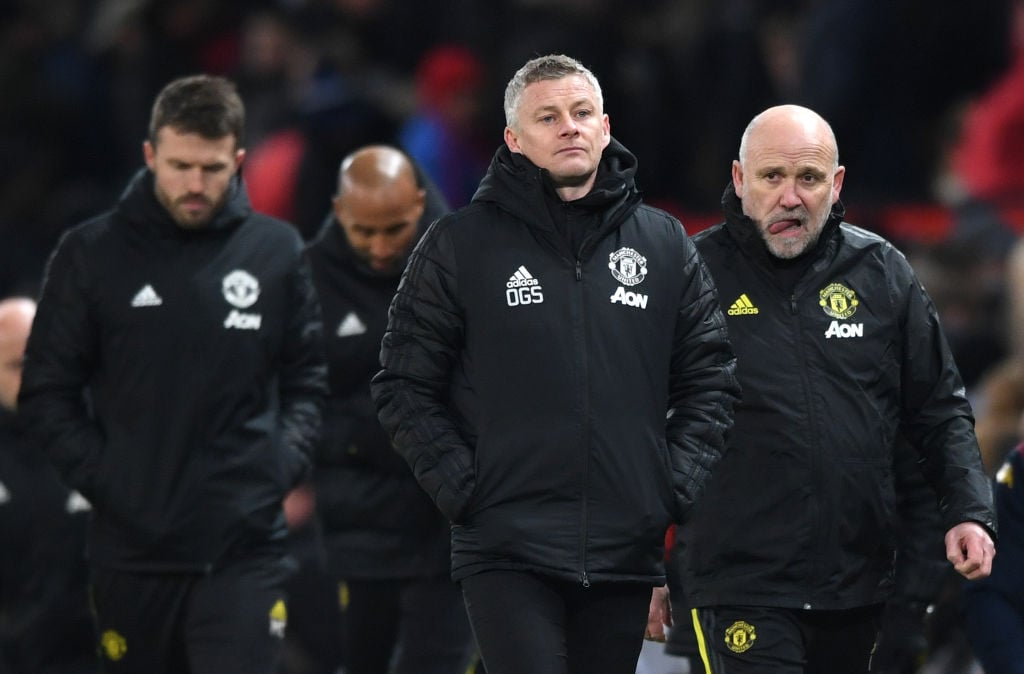 Ole Gunnar Solskjaer, Manager of Manchester United (c) walks off at half time with Assistant Manager Mike Phelan (r) during the Premier League matc...