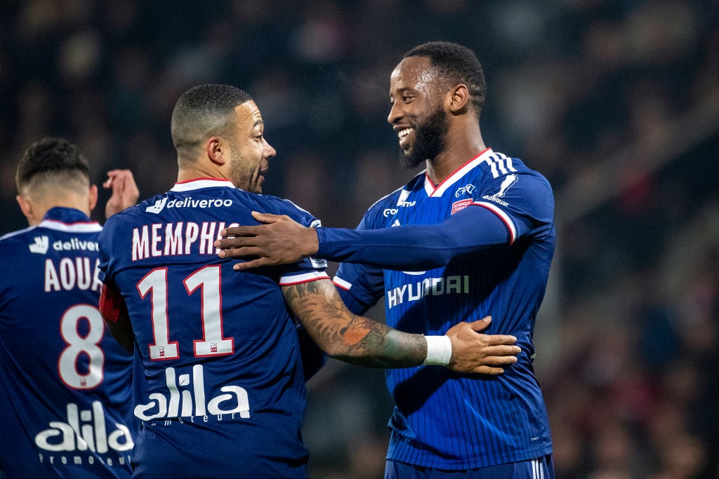 Memphis Depay #11 of Lyon is congratulated by Moussa Dembele #9 of Lyon after scoring from a penalty kick during the Nimes V Lyon, French Ligue 1, ...