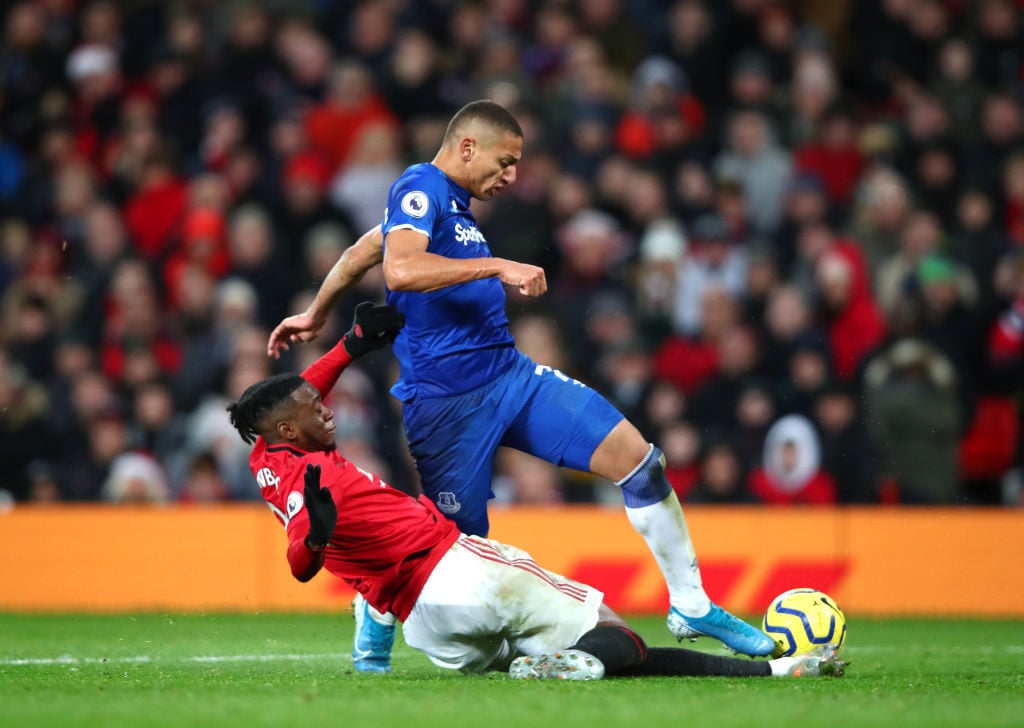 MANCHESTER, ENGLAND - DECEMBER 15: Richarlison of Everton is challenged by full-backs Aaron Wan-Bissaka of Manchester United during the Premier League match between Manchester United and Everton FC at Old Trafford on December 15, 2019 in Manchester, United Kingdom. 