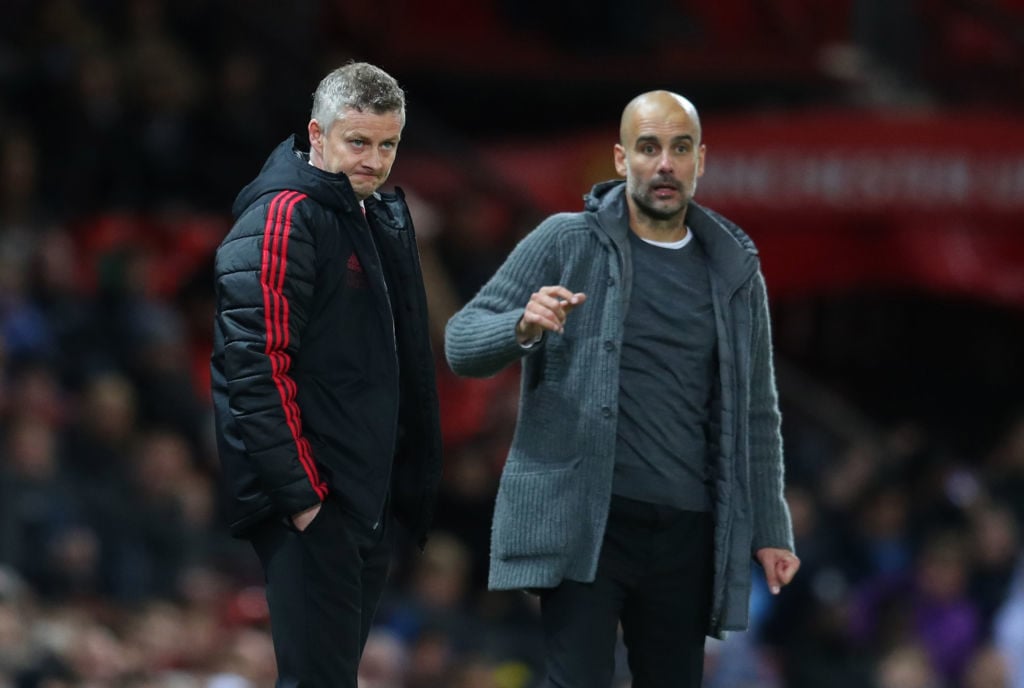 MANCHESTER, ENGLAND - APRIL 24: Ole Gunnar Solskjaer manager of Manchester United and Pep Guardiola the head coach / manager of Manchester City  during the Premier League match between Manchester United and Manchester City at Old Trafford on April 24, 2019 in Manchester, United Kingdom. 