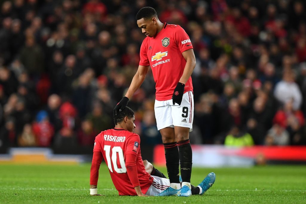 TOPSHOT - Manchester United's English striker Marcus Rashford is consoled by Manchester United's French striker Anthony Martial after seeming to pick up an injury during the English FA Cup third round-replay football match between Manchester United and Wolverhampton Wanderers at Old Trafford in Manchester, north west England, on January 15, 2020. (Photo by Paul ELLIS / AFP) / RESTRICTED TO EDITORIAL USE. No use with unauthorized audio, video, data, fixture lists, club/league logos or 'live' services. Online in-match use limited to 120 images. An additional 40 images may be used in extra time. No video emulation. Social media in-match use limited to 120 images. An additional 40 images may be used in extra time. No use in betting publications, games or single club/league/player publications. /  