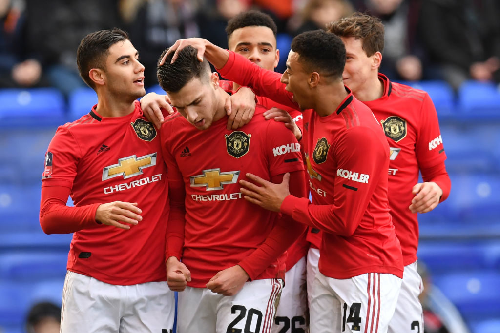Manchester United's Portuguese defender Diogo Dalot (2nd L) celebrates with teammates after scoring their second goal during the English FA Cup fourth round football match between Tranmere Rovers and Manchester United at Prenton Park in Birkenhead, north west England, on January 26, 2020. (Photo by Paul ELLIS / AFP) / RESTRICTED TO EDITORIAL USE. No use with unauthorized audio, video, data, fixture lists, club/league logos or 'live' services. Online in-match use limited to 120 images. An additional 40 images may be used in extra time. No video emulation. Social media in-match use limited to 120 images. An additional 40 images may be used in extra time. No use in betting publications, games or single club/league/player publications. /  