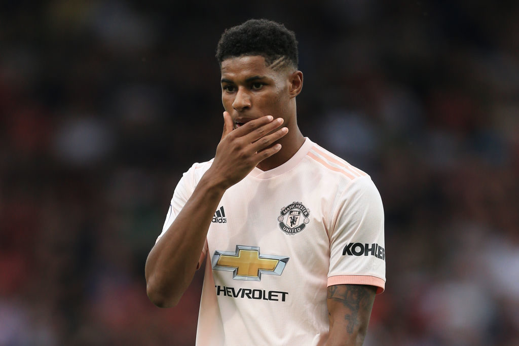 Man Utd star Marcus Rashford steps out in a white shirt and a beaded  necklace at Paris Fashion Week