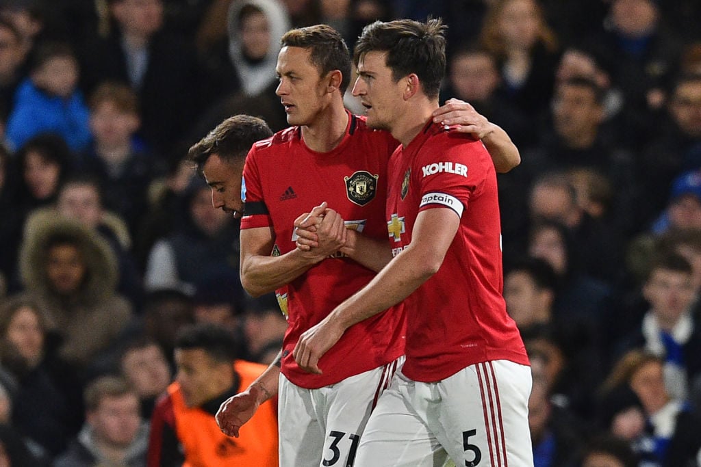 Manchester United's English defender Harry Maguire (R) is congratulated by Manchester United's Serbian midfielder Nemanja Matic (L) after he scores their second goal during the English Premier League football match between Chelsea and Manchester United at Stamford Bridge in London on February 17, 2020. (Photo by Glyn KIRK / AFP) / RESTRICTED TO EDITORIAL USE. No use with unauthorized audio, video, data, fixture lists, club/league logos or 'live' services. Online in-match use limited to 120 images. An additional 40 images may be used in extra time. No video emulation. Social media in-match use limited to 120 images. An additional 40 images may be used in extra time. No use in betting publications, games or single club/league/player publications. / 