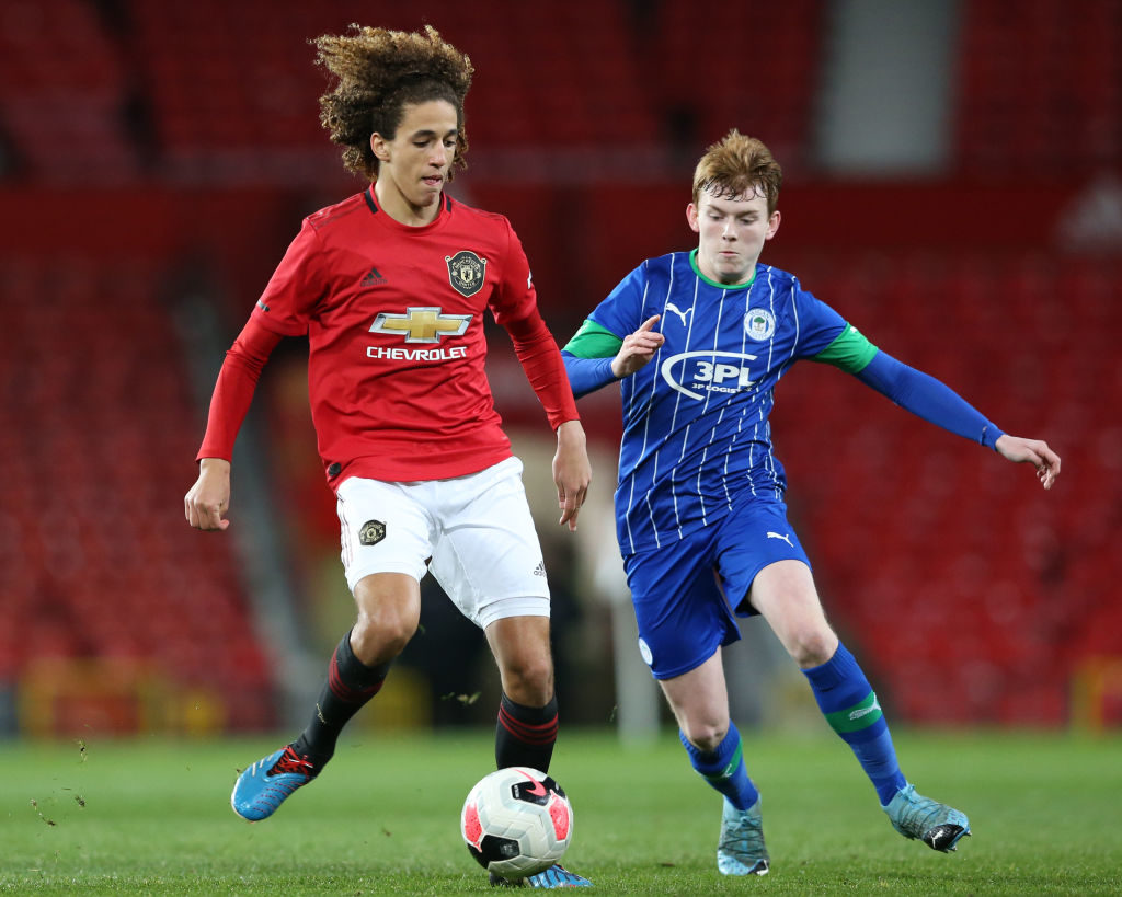 MANCHESTER, ENGLAND - FEBRUARY 28: Hannibal Mejbri of Manchester United on the ball with Sean McGurk of Wigan Athletic during the FA Youth Cup: Sixth Round match between Manchester United and Wigan Athletic at Old Trafford on February 28, 2020 in Manchester, England. 