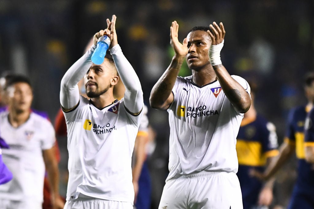 Antonio Valencia and Franklin Guerra Cedeño of Liga Deportiva Universitaria acknowledge the fans after a match between Boca Juniors and Liga Deport...