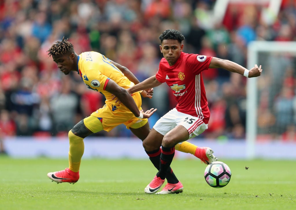 Demetri Mitchell of Manchester United and Wilfried Zaha of Crystal Palace during the Premier League match between Manchester United and Crystal Pal...