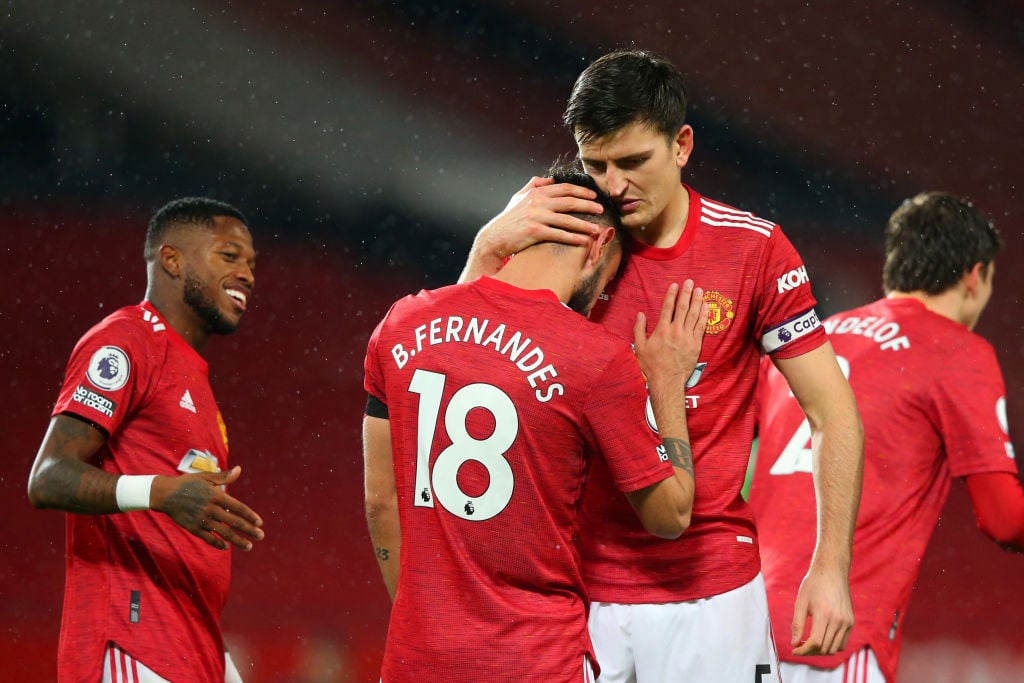 MANCHESTER, ENGLAND - NOVEMBER 21: Bruno Fernandes of Manchester United celebrates with teammate Harry Maguire after scoring his team's first goal during the Premier League match between Manchester United and West Bromwich Albion at Old Trafford on November 21, 2020 in Manchester, England. Sporting stadiums around the UK remain under strict restrictions due to the Coronavirus Pandemic as Government social distancing laws prohibit fans inside venues resulting in games being played behind closed doors. 
