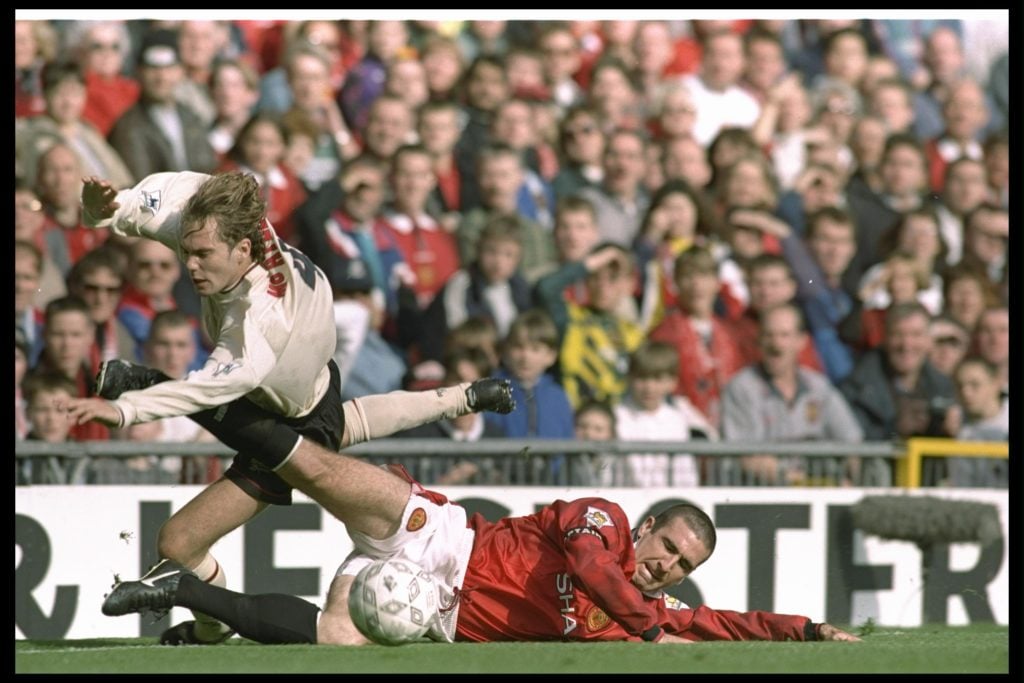 Jason McAteer of Liverpool (left) is brought down by Eric Cantona of Manchester United