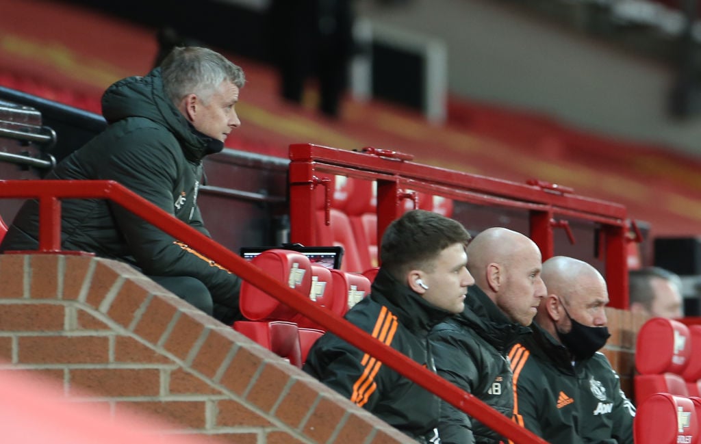 MANCHESTER, ENGLAND - FEBRUARY 21: Manager Ole Gunnar Solskjaer of Manchester United watches from the dugout duringthe Premier League match between Manchester United and Newcastle United at Old Trafford on February 21, 2021 in Manchester, England. 