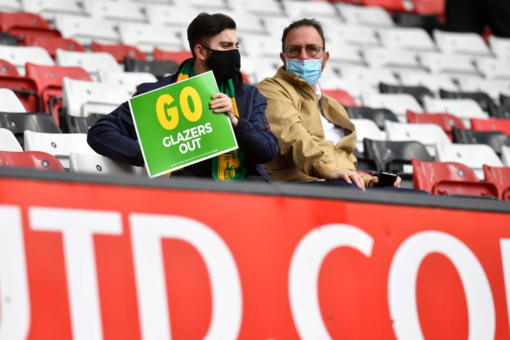 Manchester United fans wear green and gold and show anti-Glazer placards at Old Trafford