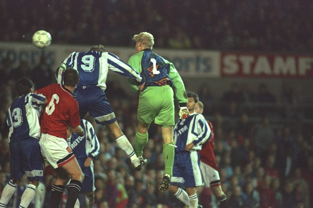 Peter Schmeichel #1 of Manchester United heads in a goal during the UEFA Cup first round second leg match against Rotor Volgograd at Old Trafford i...