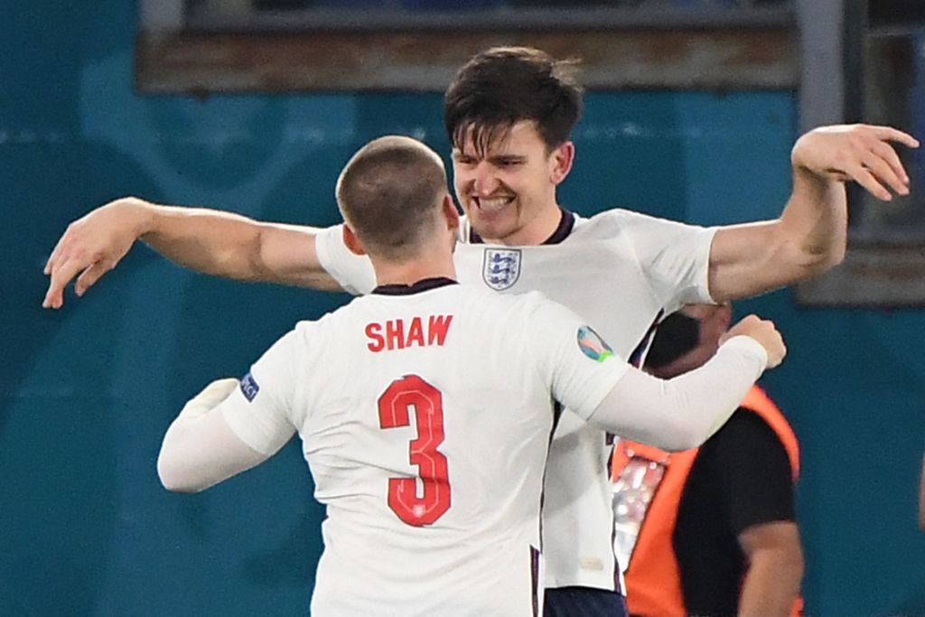 TOPSHOT - England's defender Harry Maguire (back) celebrates with England's defender Luke Shaw after scoring the second goal during the UEFA EURO 2...