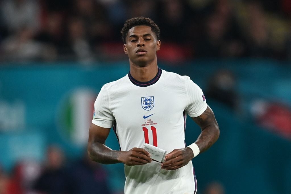 England's forward Marcus Rashford carries a note during the UEFA EURO 2020 final football match between Italy and England at the Wembley Stadium in...