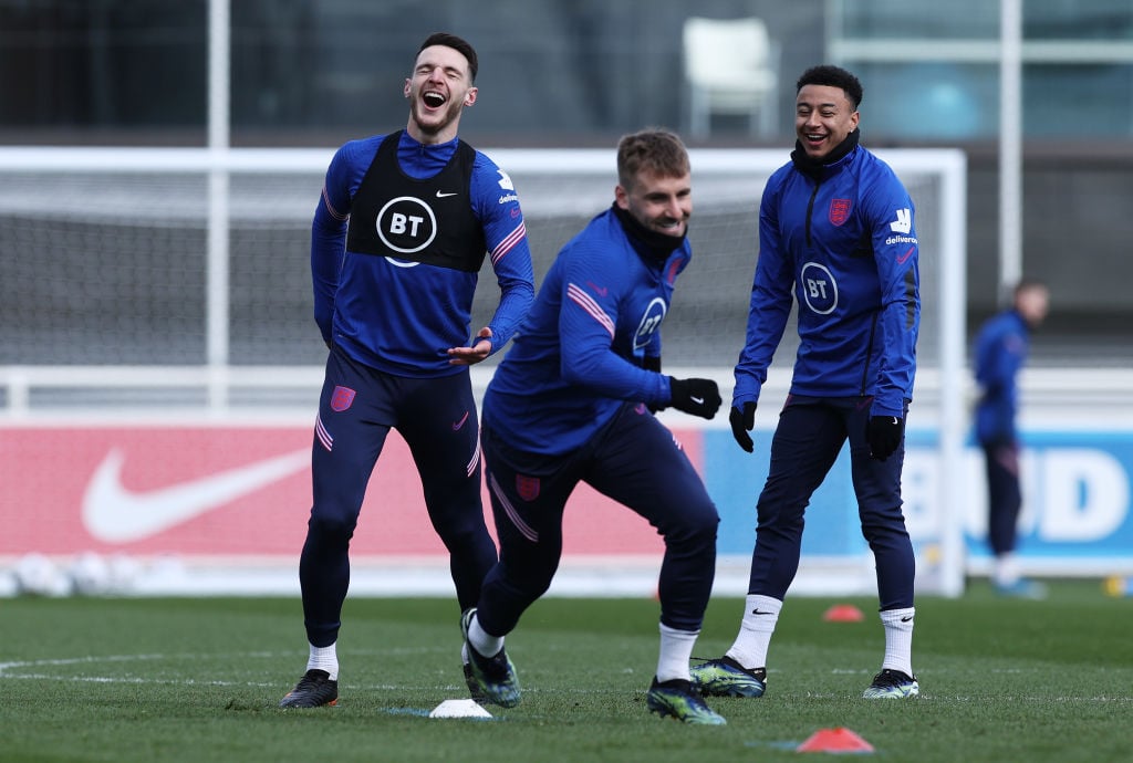 Declan Rice, Luke Shaw and Jesse Lingard of England react during a training session ahead of an upcoming FIFA World Cup Qatar 2022 Euro Qualifier a...