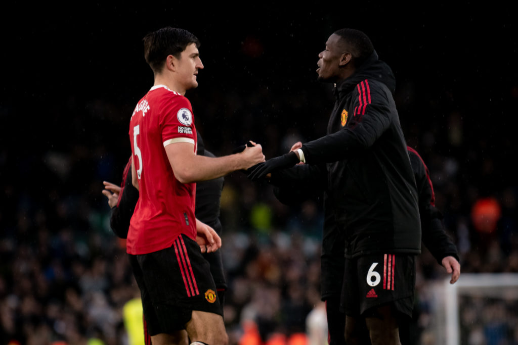 Paul Pogba and Harry Maguire shaking hands while both play for Manchester United.