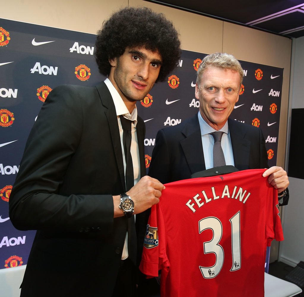 Marouane Fellaini of Manchester United poses with manager David Moyes and a United shirt after the press conference to announce his signing at Old ...