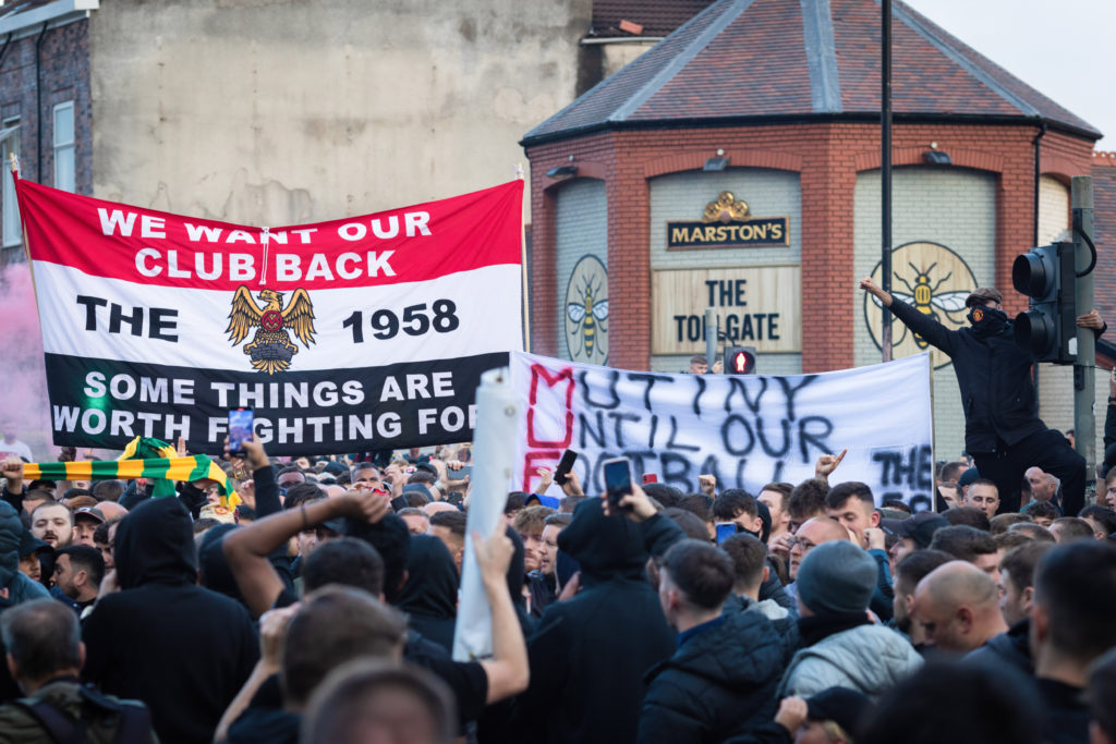 Manchester United fans await the start of the march to Old