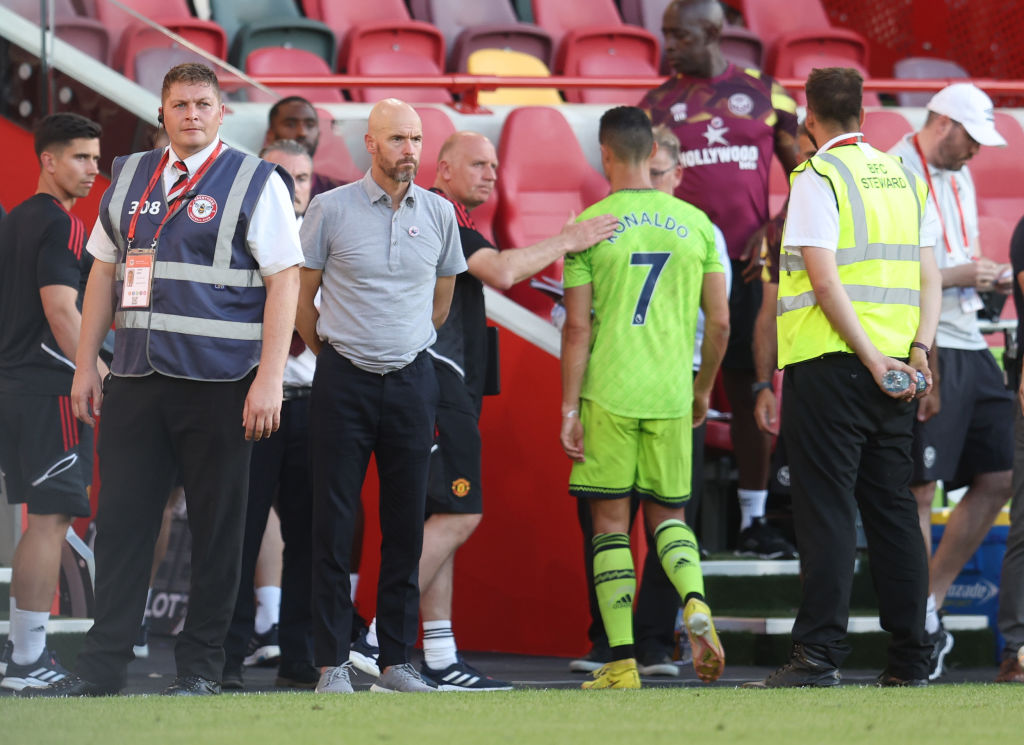 Erik ten Hag manager of Manchester United looks on as Cristiano Ronaldo walks past him following the Premier League match between Brentford FC and ...