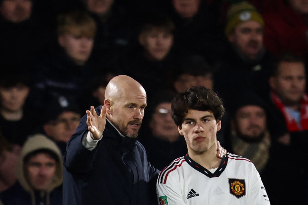 Manchester United's Dutch manager Erik ten Hag (L) gives indications to Manchester United's Uruguayan midfielder Facundo Pellistri (R) before enter...