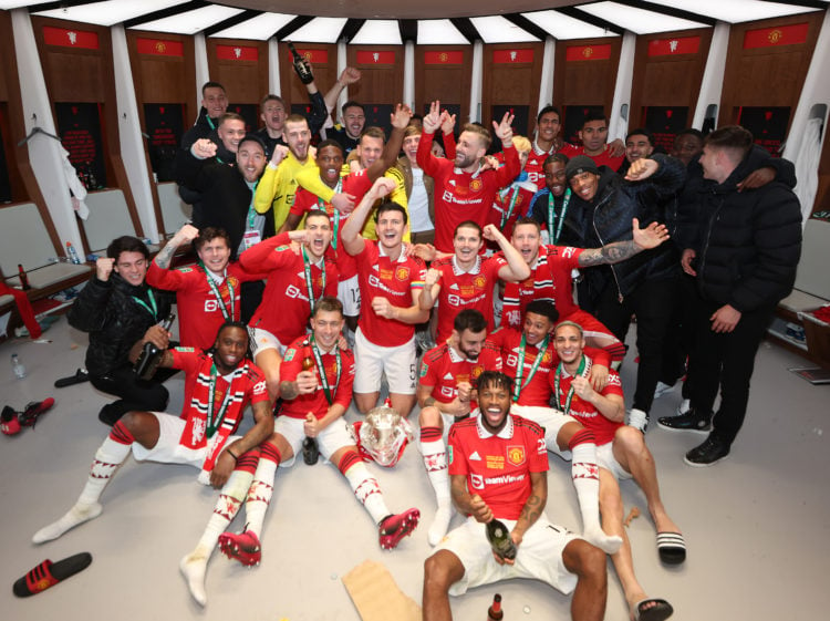 Manchester United's players pose for dressing room pictures with Carabao Cup trophy