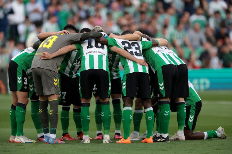 The Real Betis players form a huddle prior to kick off in the UEFA Europa League round of 16 leg two match between Real Betis and Manchester United...