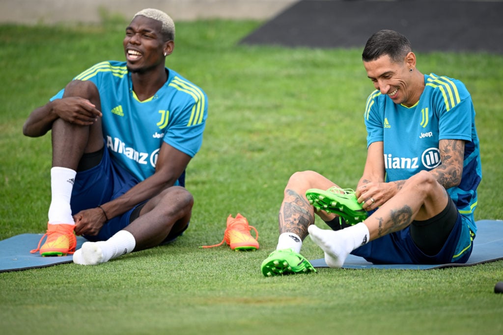 Paul Pogba and Angel Di Maria smile during a training session at JTC on July 12, 2022 in Turin, Italy.