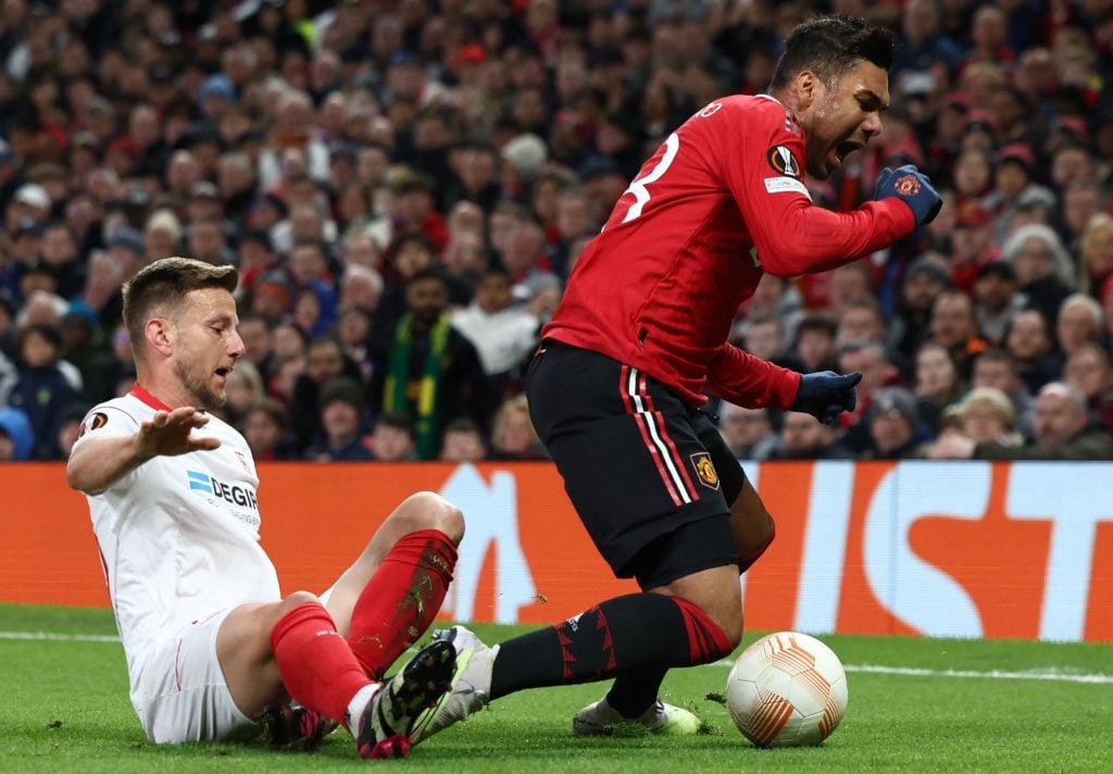 Sevilla's Croatian midfielder Ivan Rakitic (L) fouls Manchester United's Brazilian midfielder Casemiro during the UEFA Europa league quarter-final,...