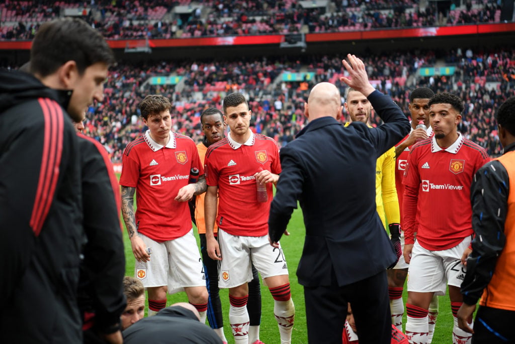 Former Manchester United manager Erik ten Hag talks to his former players before extra time during the Emirates FA Cup semi-final match between Brighton and Manchester United at Wembley Stadium in 2023 in London.