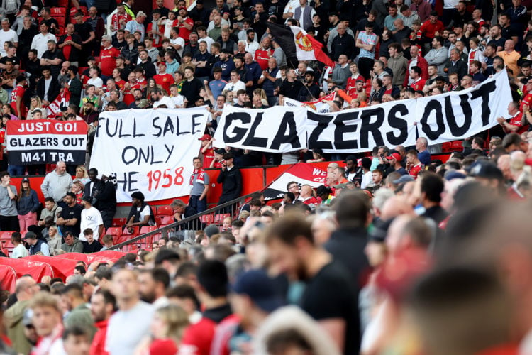 Fans hold banners which read 'Full sale only' and 'Glazers Out' prior to the Premier League match between Manchester United and Chelsea FC at Old T...