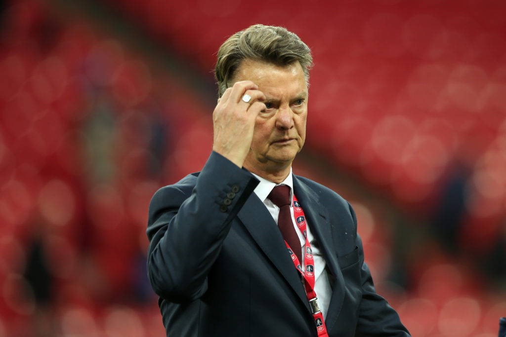 Manchester United Managr Louis van Gaal watches his players celebrate following his side's 1-2 victory at the end of extra time during The Emirates...