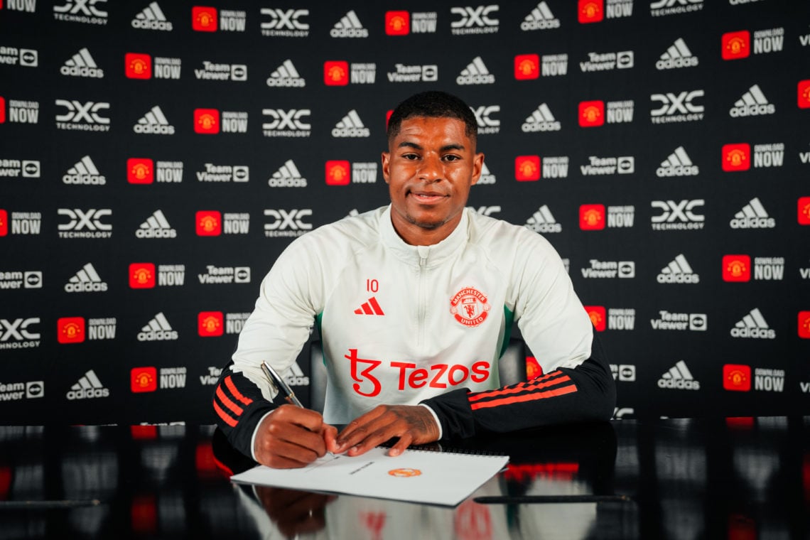 Diogo Dalot reacts as Marcus Rashford pictured signing new contract