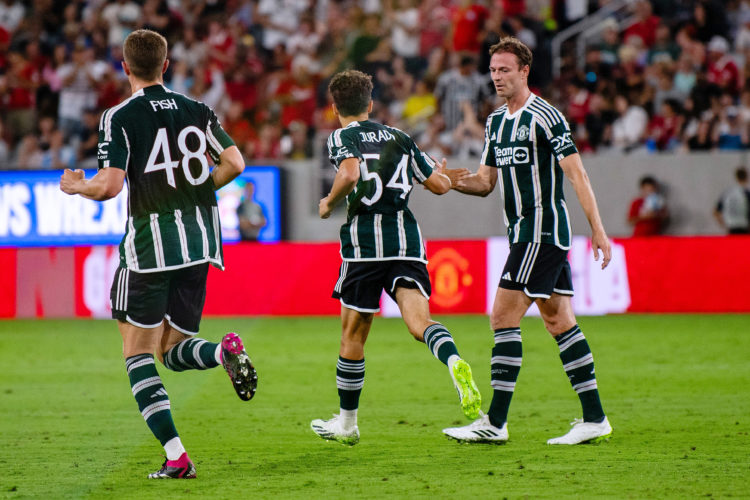 Marc Jurado of Manchester United celebrates with team mate Jonny Evans after scoring their sides first goal during the pre-season friendly match be...