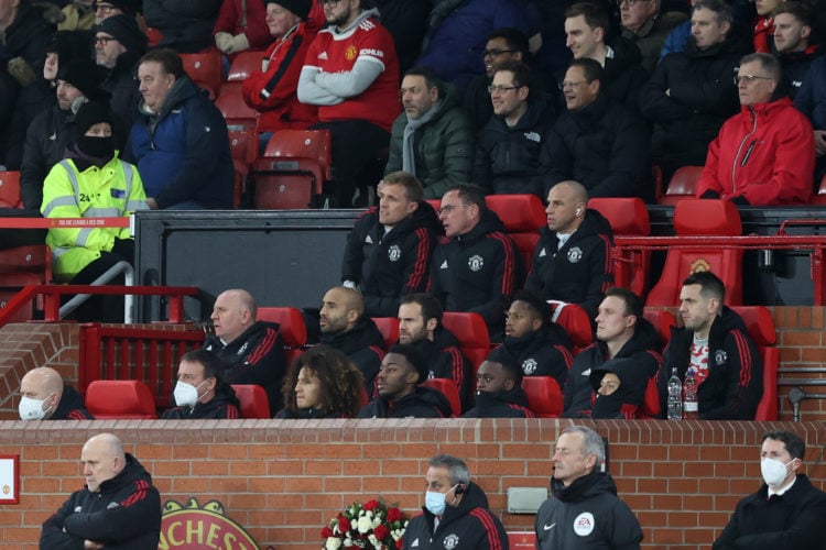 Manchester United manager Ralf Rangnick sits with his staff and substitutes during the Emirates FA Cup Fourth Round match between Manchester United...