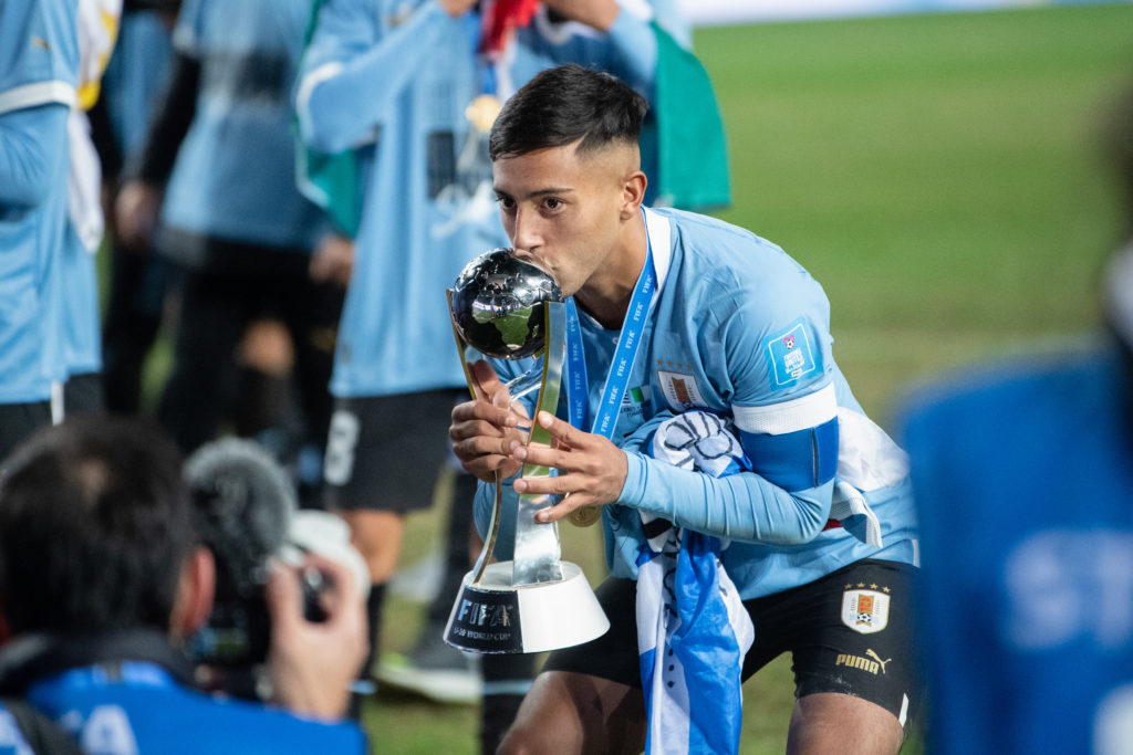 Fabricio Diaz of Uruguay celebrates with the champion trophy