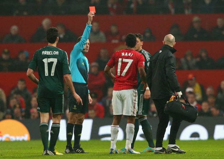 Referee Bahattin Duran sends off Nani of Manchester United during the UEFA Champions League Round of 16 Second leg match between Manchester United ...