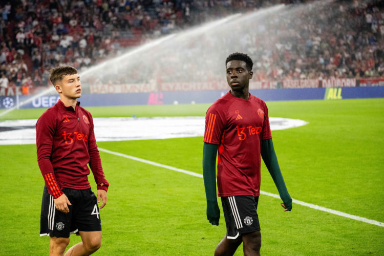 Dan Gore and Omari Forson of Manchester United warm up ahead of the UEFA Champions League match between FC Bayern München and Manchester United at ...