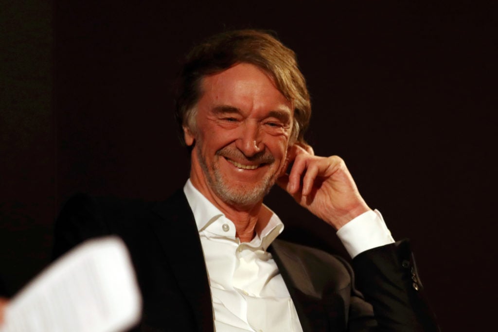 INEOS Founder and Chairman Sir Jim Ratcliffe (L) reacts during a press conference regarding INEOS and Mercedes future partnership at The Royal Auto...