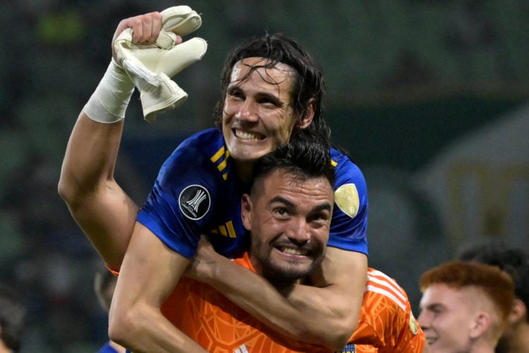 Boca Juniors' Uruguayan forward Edinson Cavani (Top) and goalkeeper Sergio Romero celebrate after defeating Palmeiras on the penalty shoot-out duri...