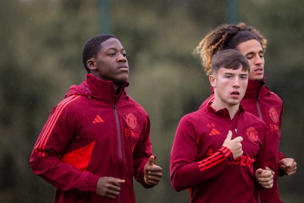 Kobbie Mainoo, Dan Gore and Hannibal Mejbri of Manchester United in action during a first team training session at Carrington Training Ground on Oc...