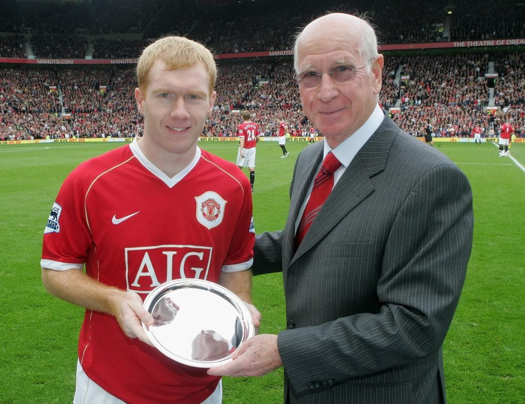 Sir Bobby Charlton presents Paul Scholes with a silver plate to commemorate his 500th Manchester United appearance ahead of the Barclays Premiershi...