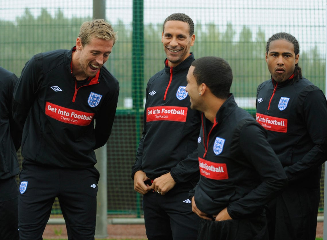 Peter Crouch shares a joke with Aaron Lennon as Rio Ferdinand and Glen Johnson look on during the England training session at London Colney on Octo...