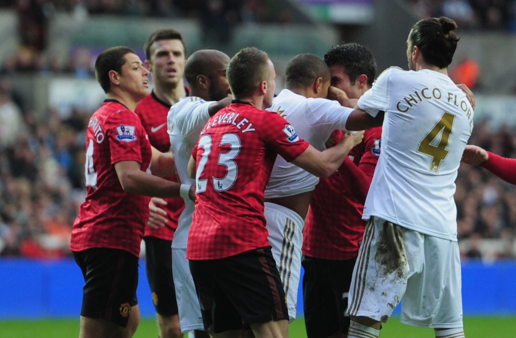 Robin Van Persie of Manchester United squares up to Ashley Williams of Swansea City during the Barclays Premier League match between Swansea City a...