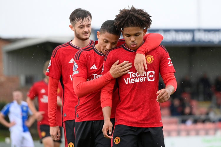 Shola Shoretire of Manchester United celebrates his goal with teammates after scoring to make it 1-2 during the Premier League 2 match between Blac...