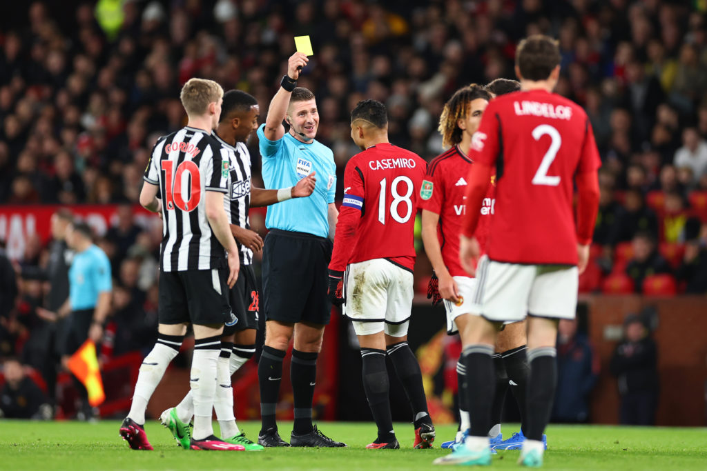 Casemiro of Manchester United gets a yellow card during the Carabao Cup Fourth Round match between Manchester United and Newcastle United at Old Tr...