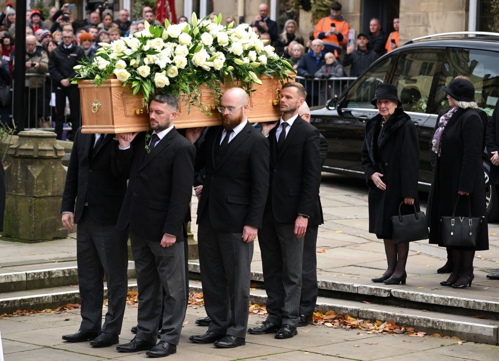 The widow of Sir Bobby Charlton, Lady Norma Charlton walks behind her husband's coffin during his funeral at Manchester Cathedral on November 13, 2...